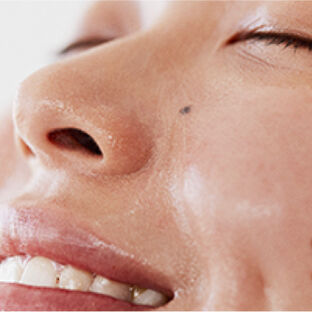 Close up of model with Kombucha Cleansing Treatment on her face