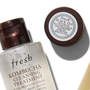 A white banner with Fresh's best-selling products in miniature form on top of it