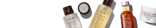 A white banner with Fresh's best-selling products in miniature form on top of it