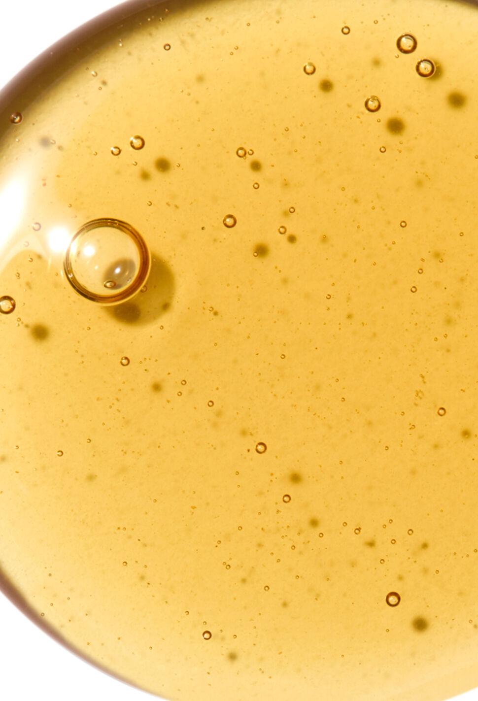 Close-up of golden oil with bubbles