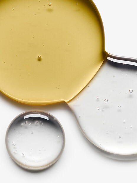Close up of yellow and clear liquid combining