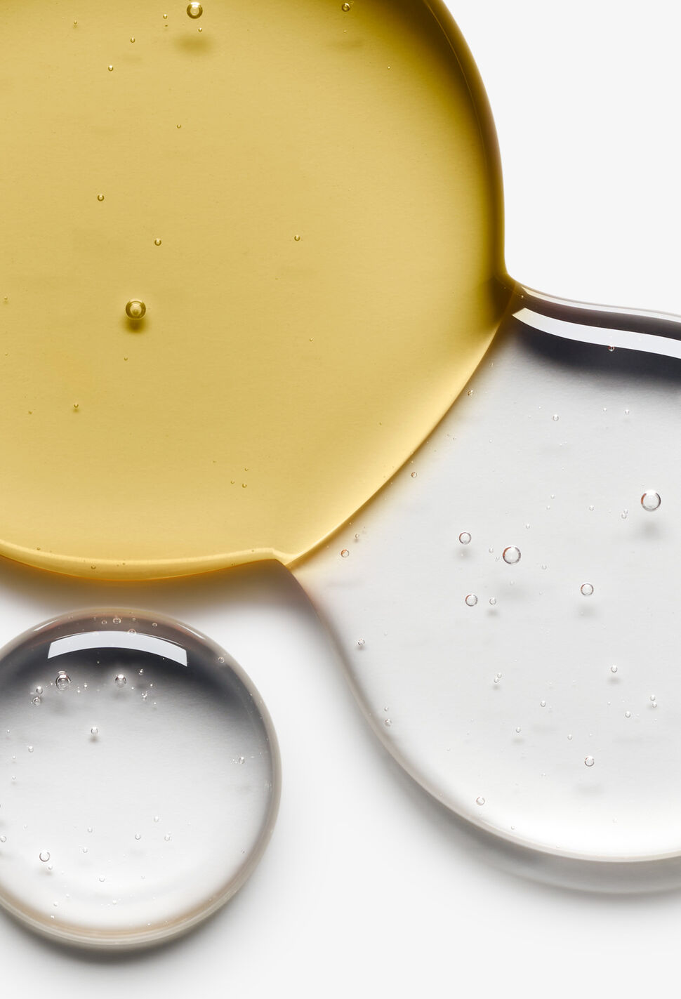 Close up of yellow and clear liquid combining