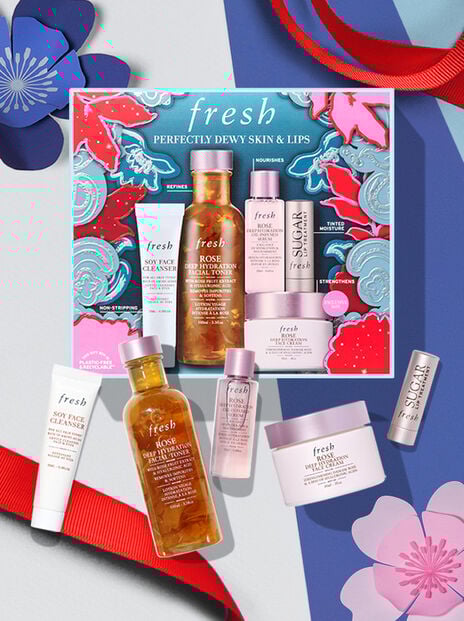 fresh holiday gift set against blue background and red ribbon