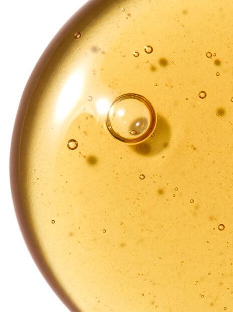 Close-up of golden oil with bubbles