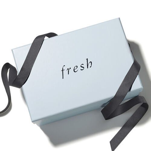A Fresh light blue gift box with navy ribbon on a white background.