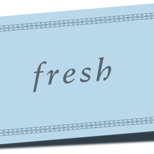 Patterned Fresh gift card overlaid on top of red ribbon against a white background.