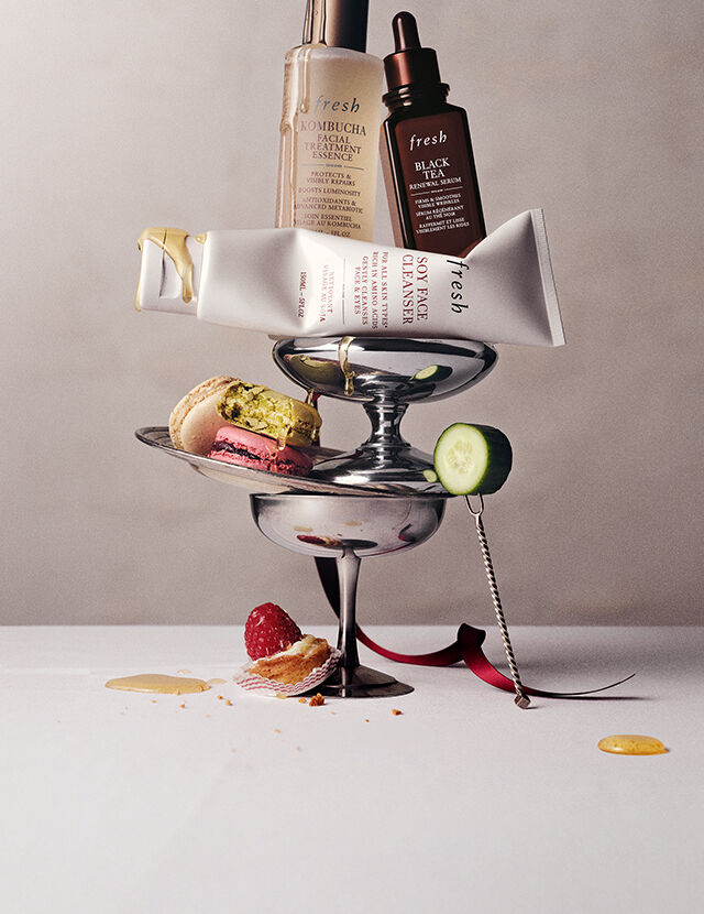 soy face cleanser bottle with bubbles on dark background